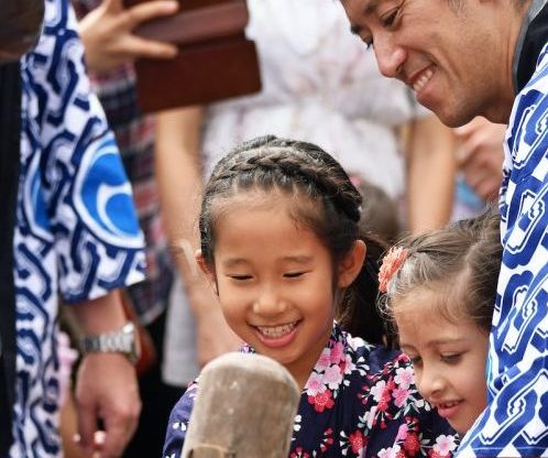 man holding axe beside people